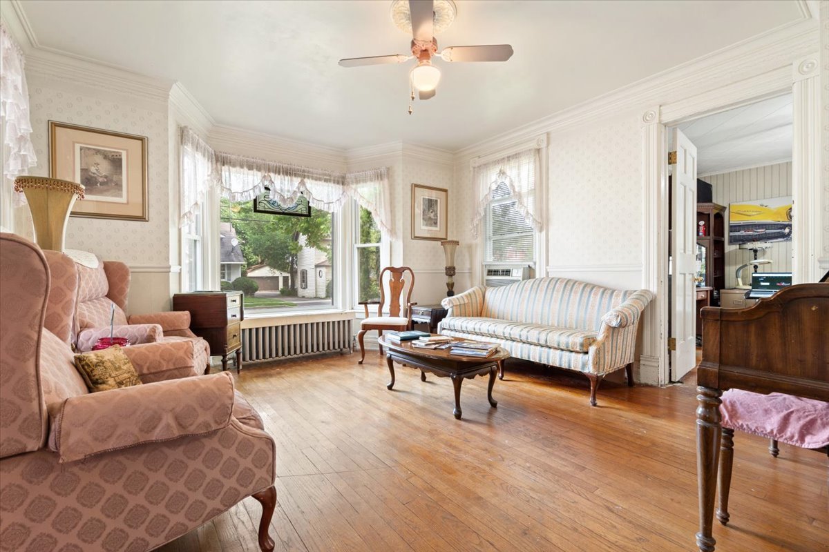 116 Spring Street Cary, IL 60013 - Photo 10 of 45 a living room with furniture and a wooden floor
