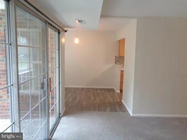 a view of hallway with wooden floor
