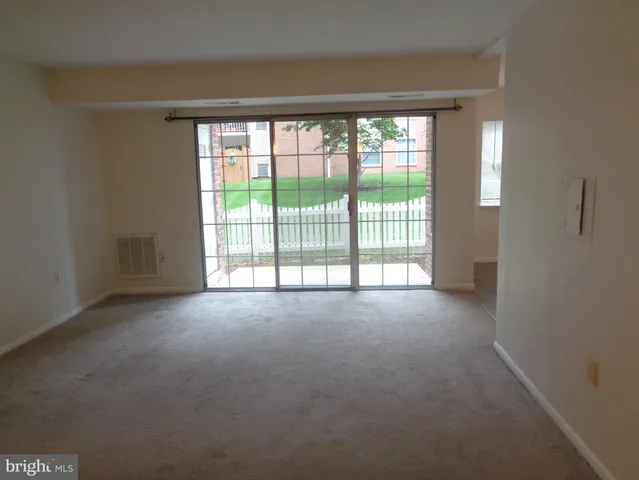 a view of empty room with floor to ceiling window