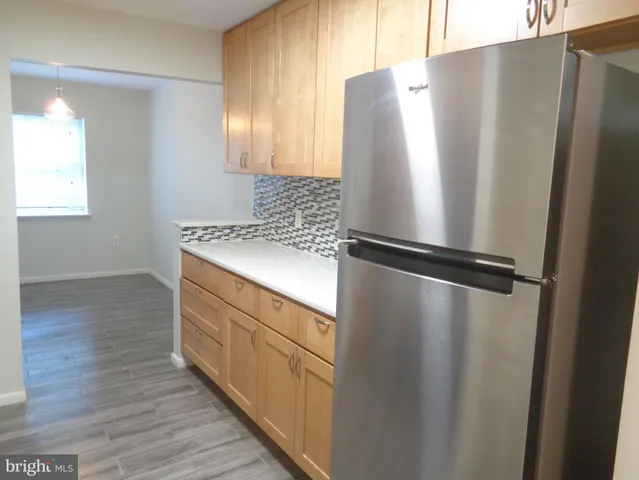 a kitchen with a refrigerator and a sink