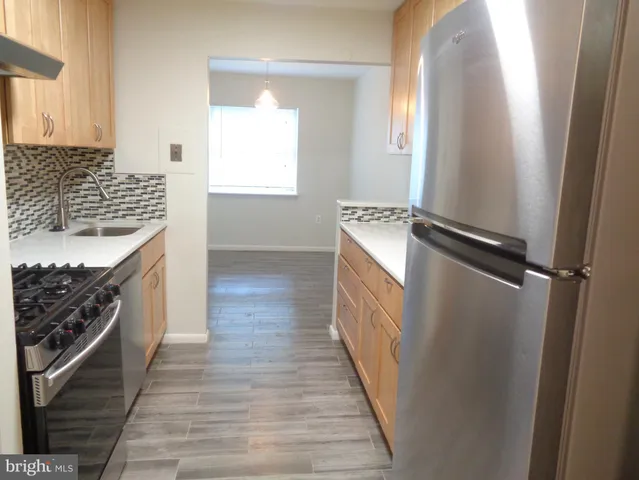a kitchen with white cabinets and a stove