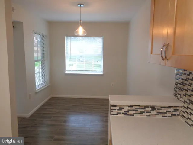 a view of a room with wooden floor and window