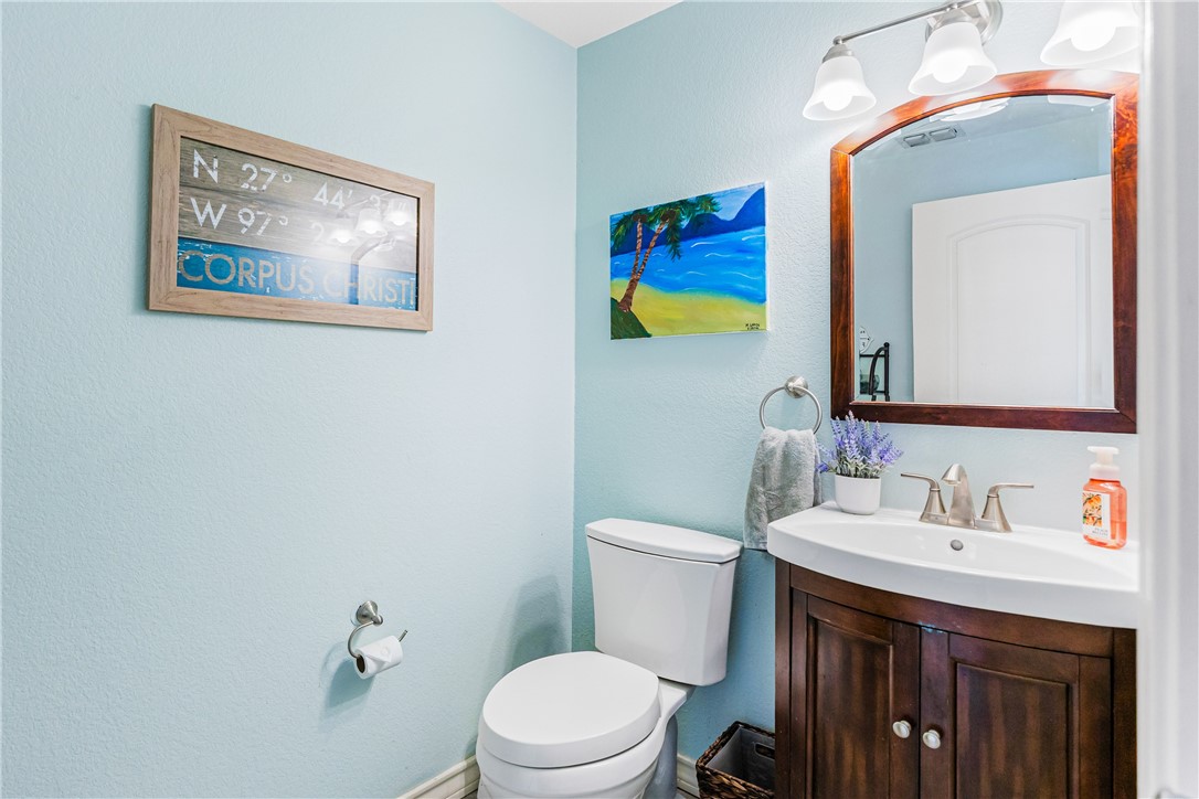 3350 Mavis Drive Corpus Christi, TX 78411 - Photo 14 of 40 a bathroom with a toilet a sink and mirror