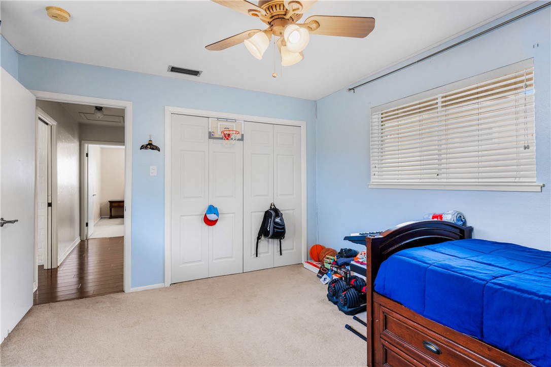 3350 Mavis Drive Corpus Christi, TX 78411 - Photo 25 of 40 a bedroom with a bed and a chandelier