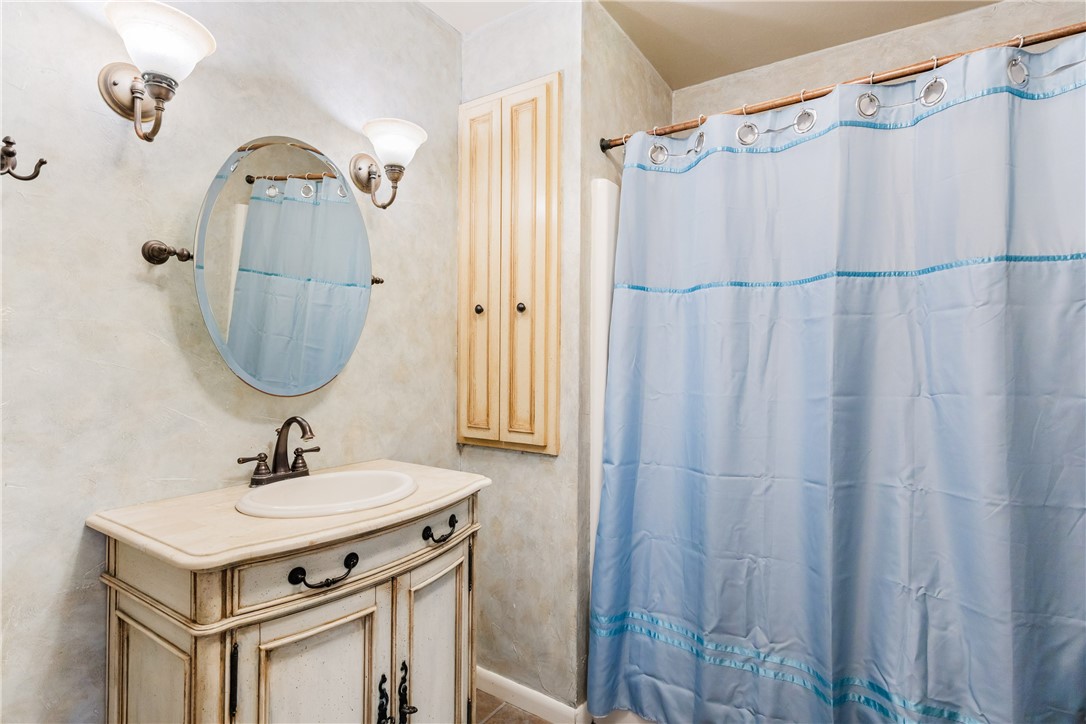 3350 Mavis Drive Corpus Christi, TX 78411 - Photo 26 of 40 a bathroom with a sink a mirror a vanity and a shower