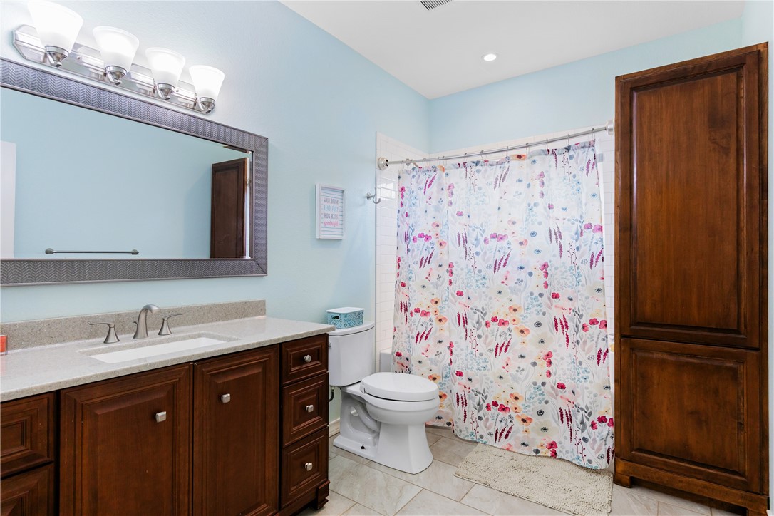 3350 Mavis Drive Corpus Christi, TX 78411 - Photo 30 of 40 a bathroom with a sink a toilet a shower and a mirror