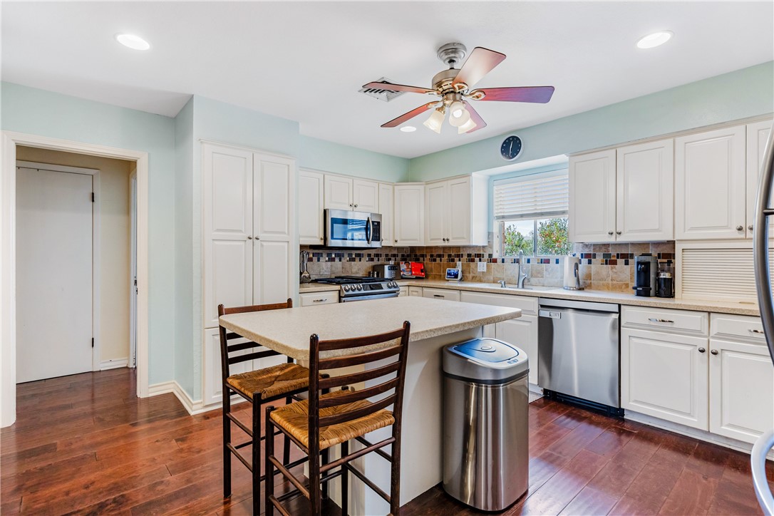 3350 Mavis Drive Corpus Christi, TX 78411 - Photo 10 of 40 a kitchen with a dining table chairs refrigerator and cabinets