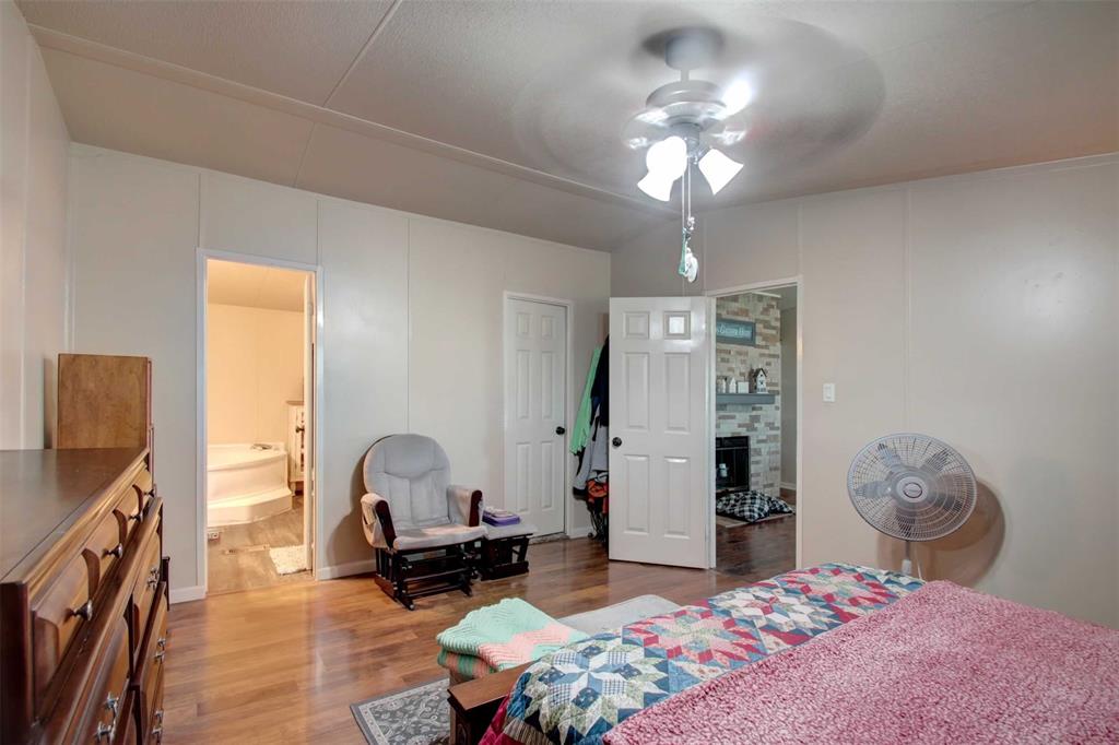 2004 Fall Creek Road Cleburne, TX 76033 - Photo 10 of 18 a living room with furniture a rug and a chandelier