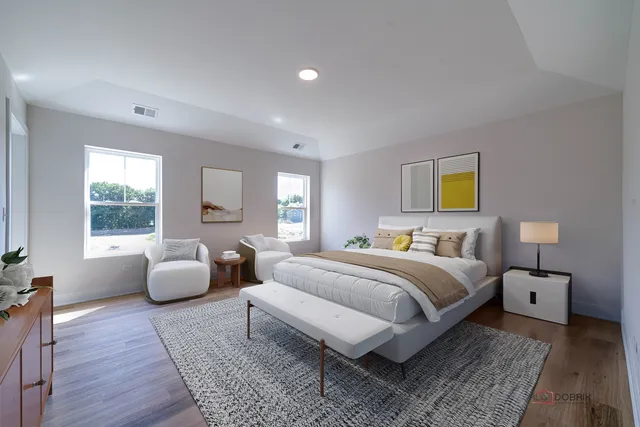 a bedroom with a bed and wooden floor