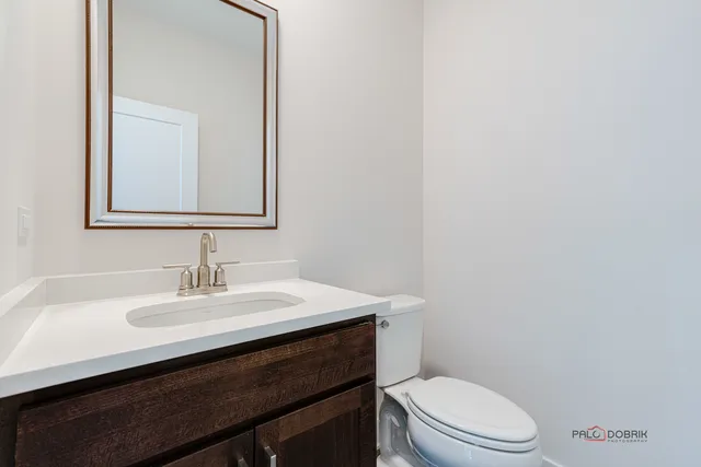 a bathroom with a sink a toilet and mirror
