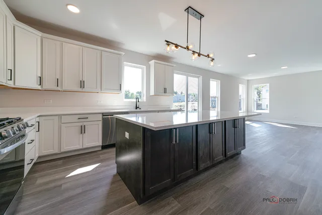 a kitchen with a sink window and cabinets