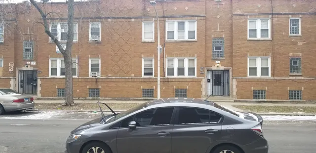 a view of a car parked in front of a brick building