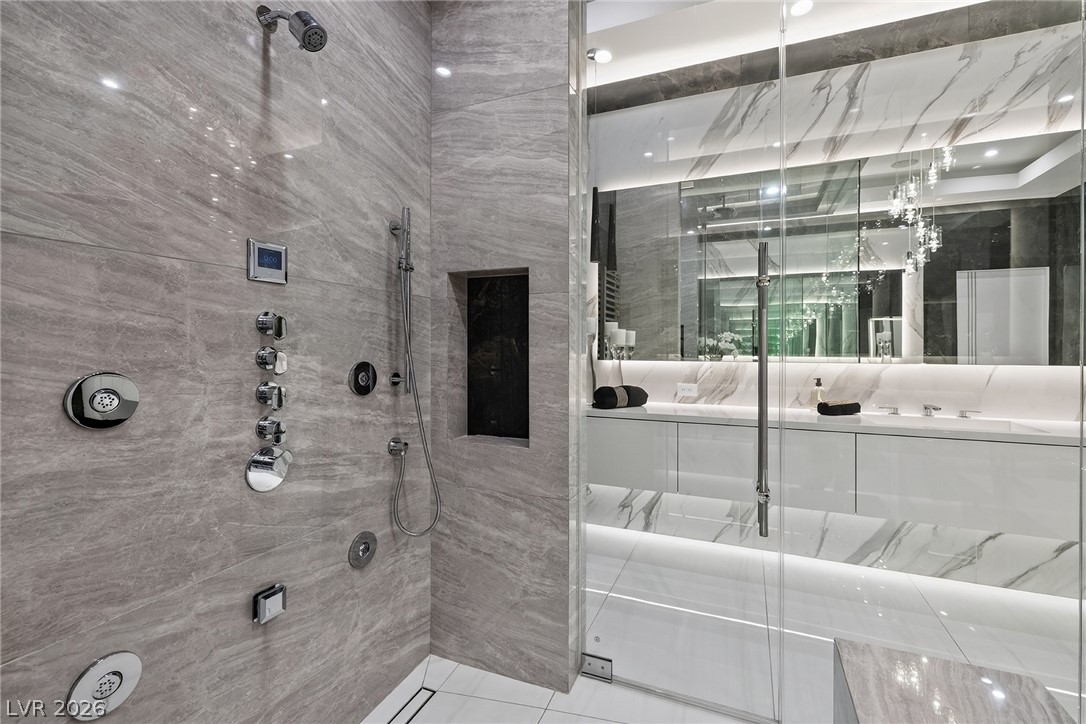 611 Cityview Ridge Drive Henderson, NV 89012 - Photo 44 of 66 Gleaming stone tile walls and a glass enclosure define this modern walk-in shower.