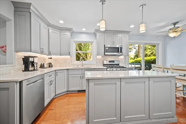 a kitchen with cabinets appliances and a window