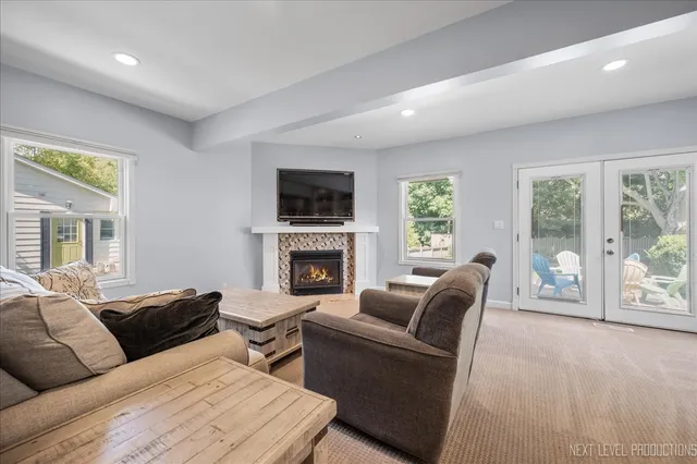 a living room with furniture a fireplace and a flat screen tv