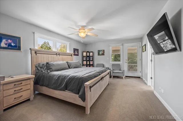 a spacious bedroom with a bed a couch and a window