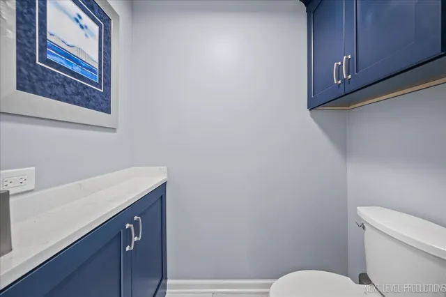 a bathroom with a toilet a sink and vanity