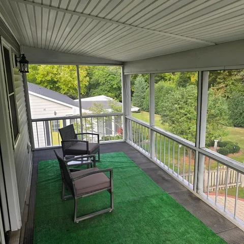 a view of a porch with furniture and garden