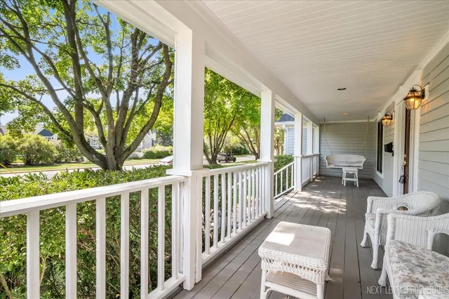 a view of a porch with furniture and wooden deck