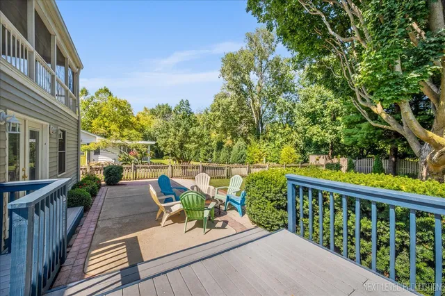 a balcony with wooden floor and outdoor seating