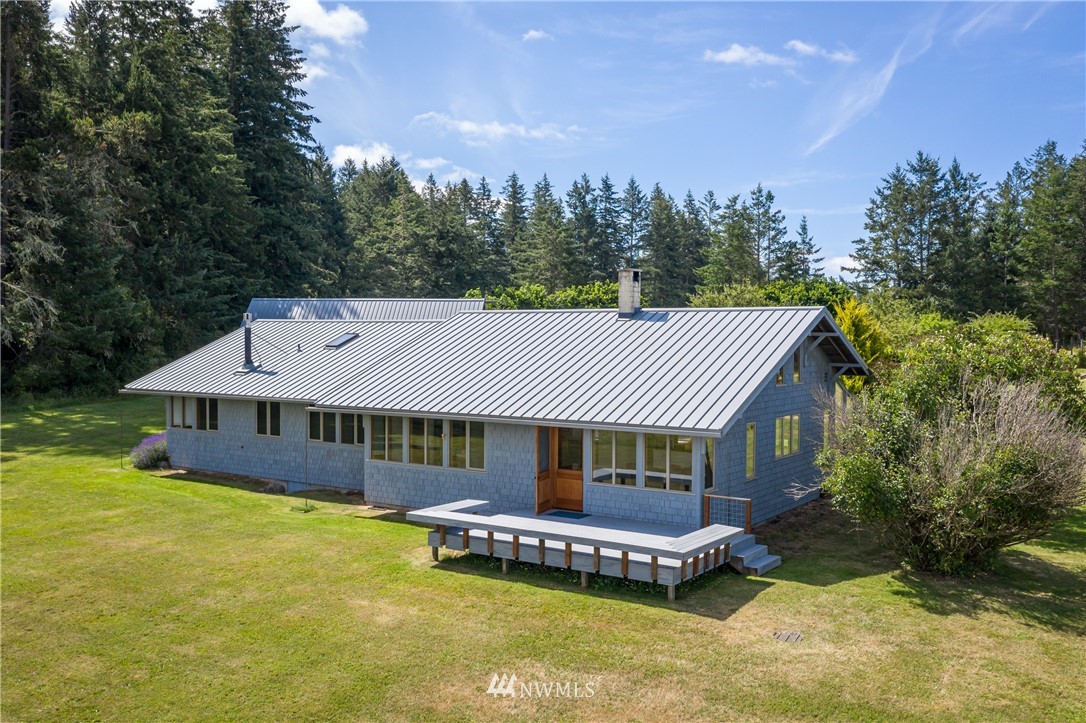257 Cross Road Lopez Island, WA 98261 - Photo 14 of 28 a front view of a house with a garden and swimming pool