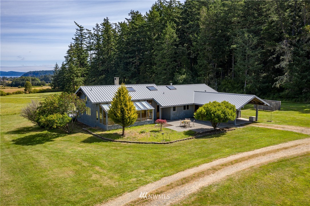 257 Cross Road Lopez Island, WA 98261 - Photo 3 of 28 a view of a house with swimming pool and yard