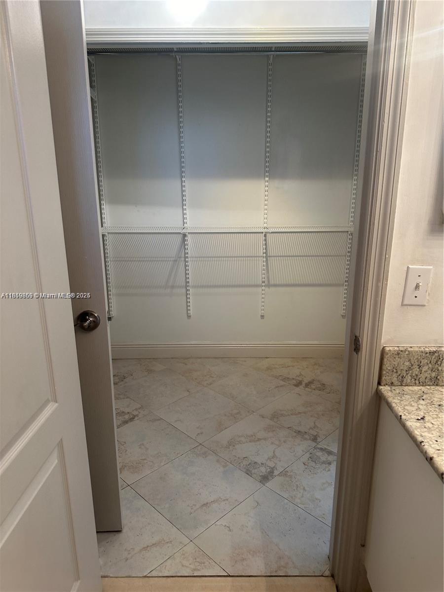 2400 Southwest 27th Avenue, Unit 406 Miami, FL 33145 - Photo 14 of 31 a bathroom with a granite countertop shower