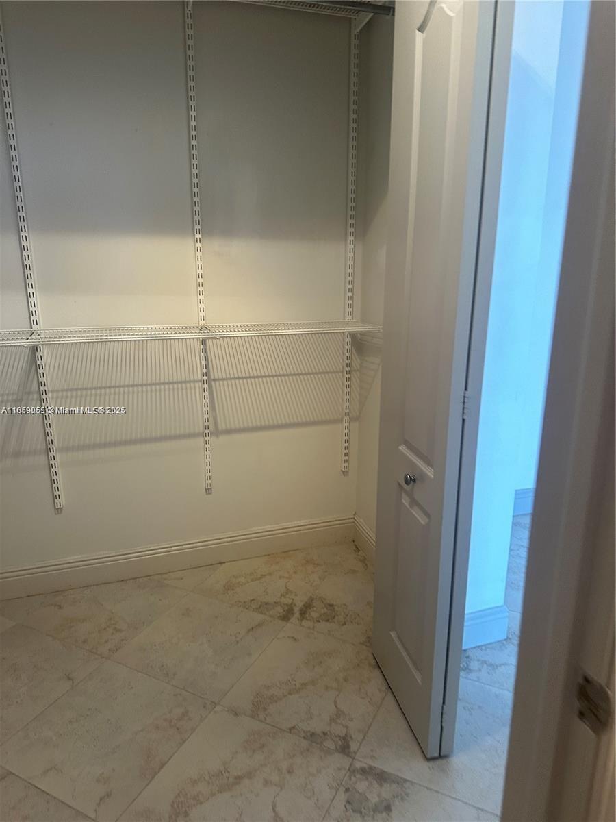 2400 Southwest 27th Avenue, Unit 406 Miami, FL 33145 - Photo 15 of 31 a bathroom with a glass shower door