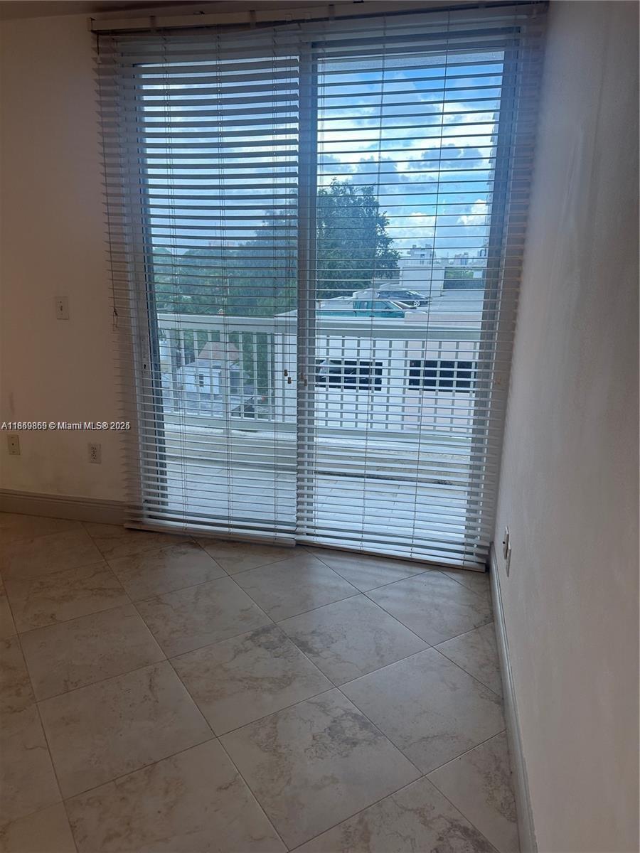 2400 Southwest 27th Avenue, Unit 406 Miami, FL 33145 - Photo 18 of 31 a view of a room with an empty space and a window
