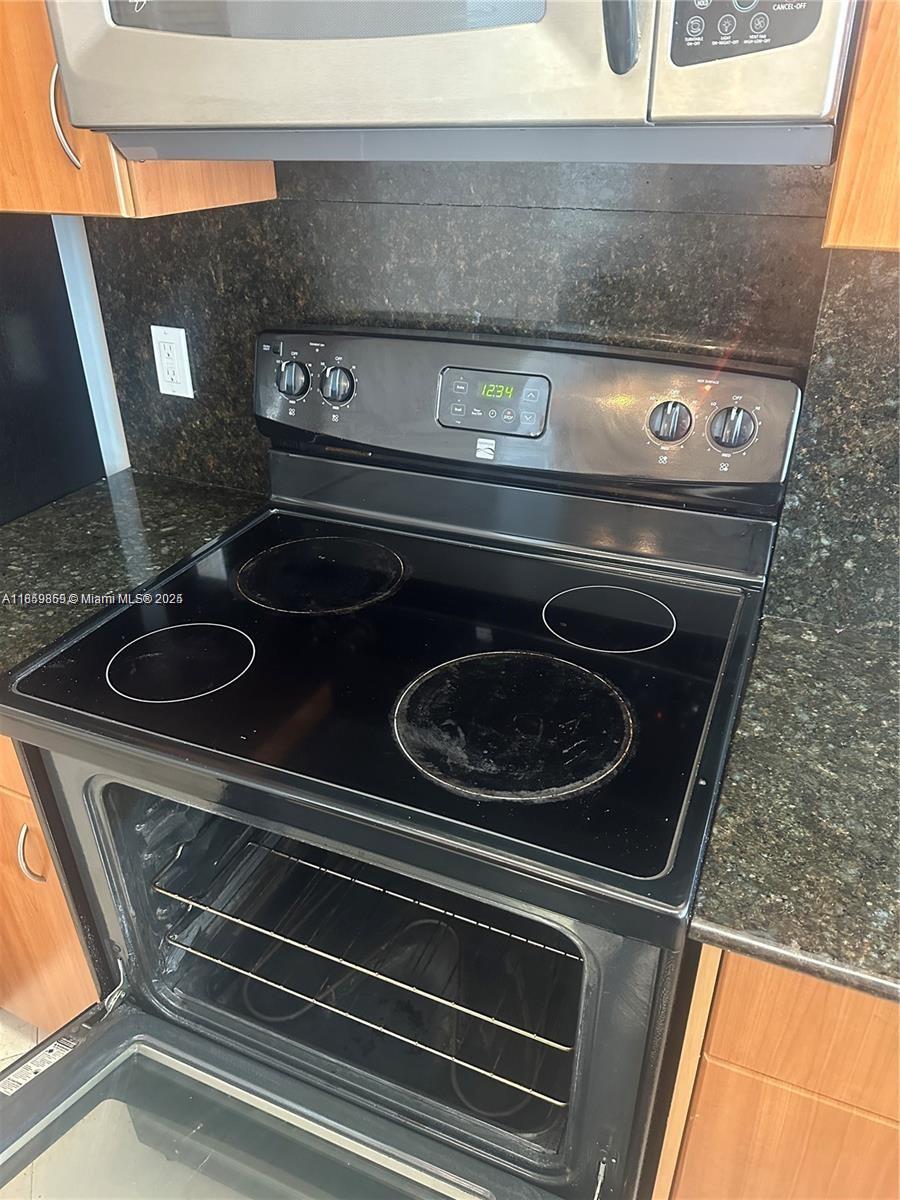 2400 Southwest 27th Avenue, Unit 406 Miami, FL 33145 - Photo 30 of 31 a stove top oven sitting inside of a kitchen