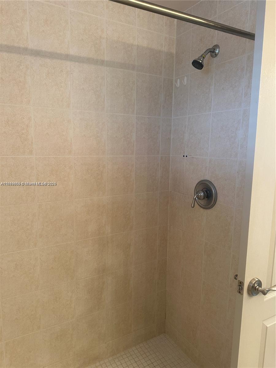 2400 Southwest 27th Avenue, Unit 406 Miami, FL 33145 - Photo 10 of 31 a bathroom with a shower
