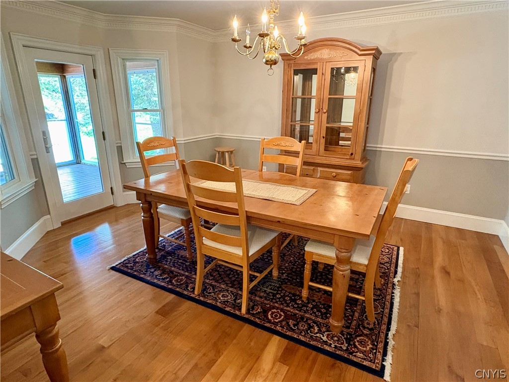7892 East Ridge Pointe Drive Manlius, NY 13066 - Photo 9 of 46 Gleaming hardwoos in the dining room with access to the screened porch.