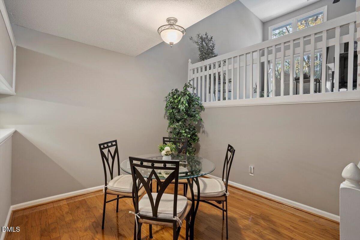 100 Hunting Chase, Unit 1D Cary, NC 27513 - Photo 13 of 29 a view of a dining room with furniture and wooden floor