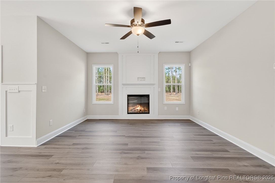 2202 Montrose (lot 3) Road Raeford, NC 28376 - Photo 11 of 44 a view of an empty room with wooden floor fireplace and a window