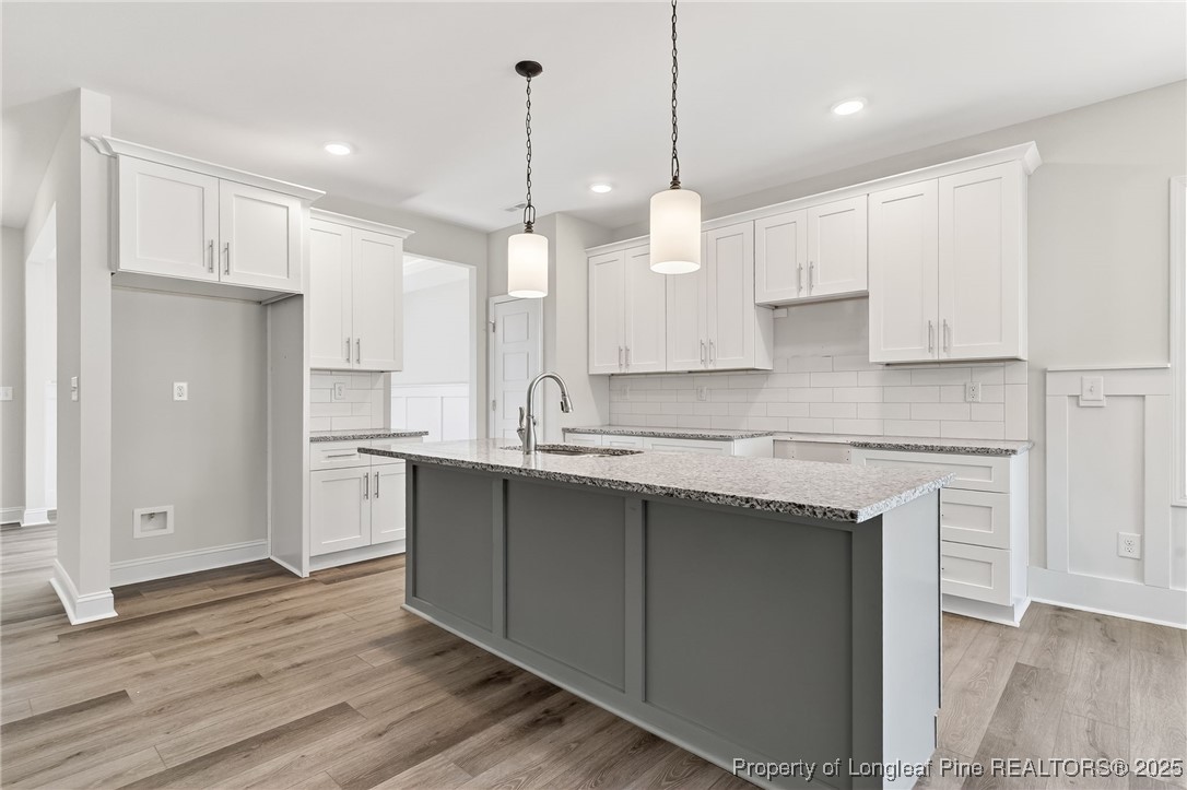 2202 Montrose (lot 3) Road Raeford, NC 28376 - Photo 15 of 44 a kitchen with kitchen island granite countertop a sink a center island stainless steel appliances and cabinets