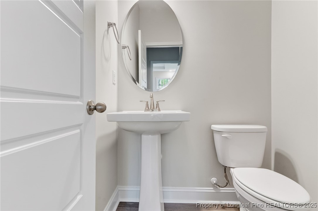2202 Montrose (lot 3) Road Raeford, NC 28376 - Photo 19 of 44 a bathroom with a toilet sink and mirror