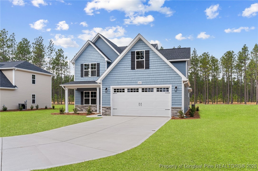 2202 Montrose (lot 3) Road Raeford, NC 28376 - Photo 3 of 44 a view of a house with yard and a garage