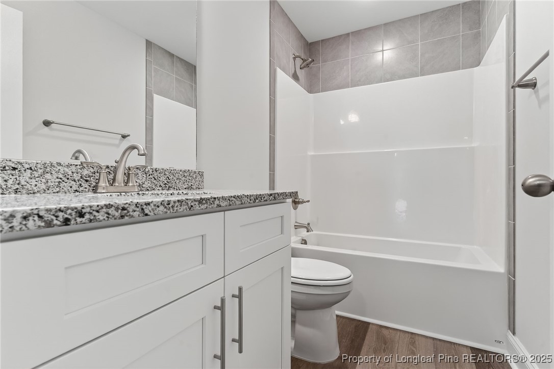 2202 Montrose (lot 3) Road Raeford, NC 28376 - Photo 35 of 44 a bathroom with a granite countertop sink toilet and shower