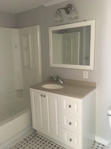 a bathroom with a sink a mirror and a bathtub