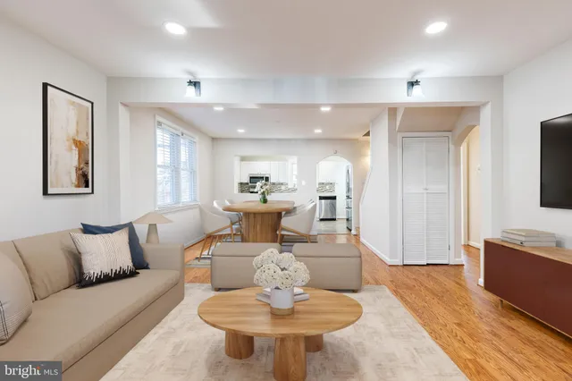 a living room with furniture and a dining table
