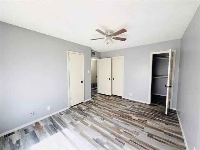 a view of a big room with wooden floor and closet