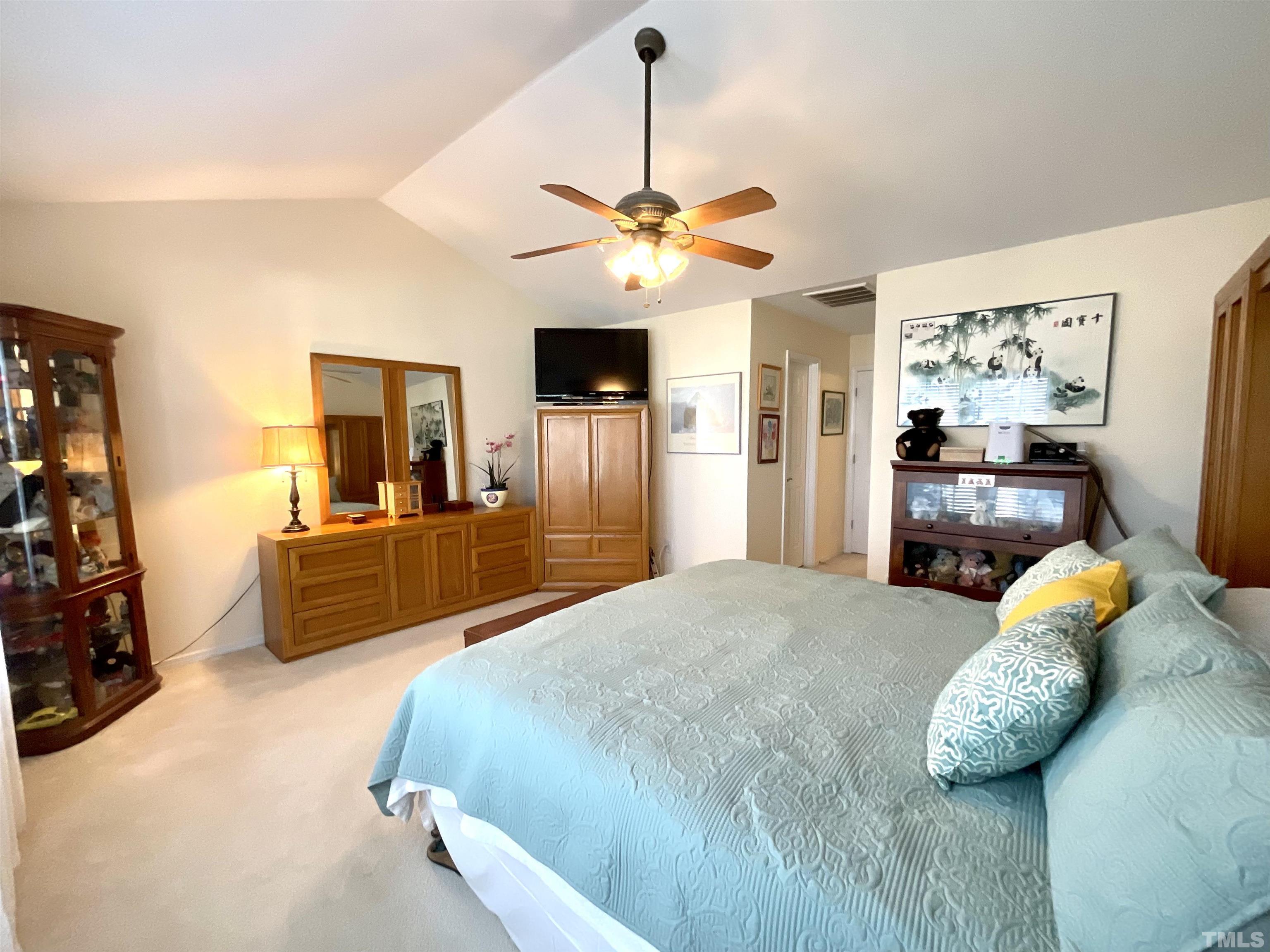 8400 Split Stone Lane Raleigh, NC 27613 - Photo 2 of 27 a bedroom with a bed and a chandelier