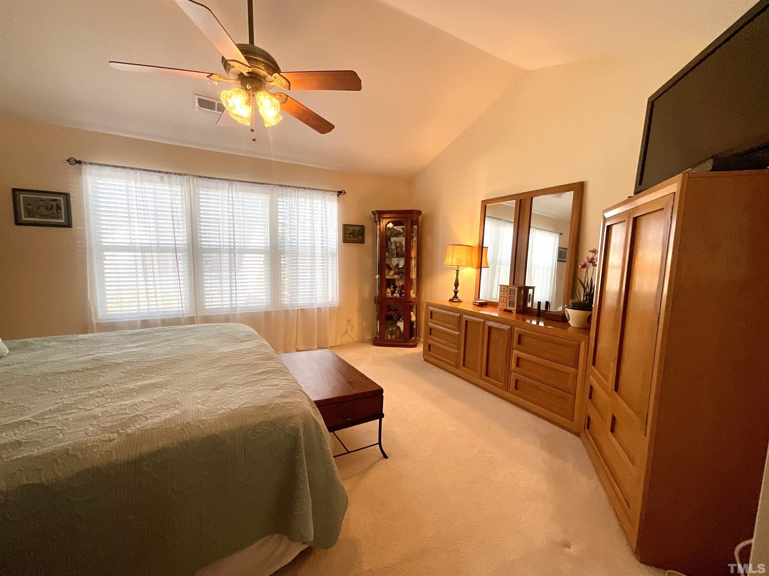 8400 Split Stone Lane Raleigh, NC 27613 - Photo 3 of 27 a bed room with a bed window and a television