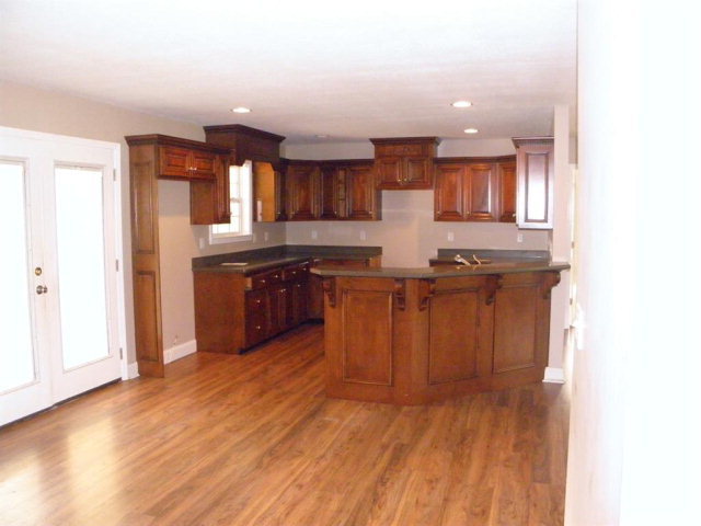 1218 Bowers Cemetery Road Cochran, GA 31014 - Photo 14 of 21 a kitchen with stainless steel appliances granite countertop a sink and a wooden cabinets