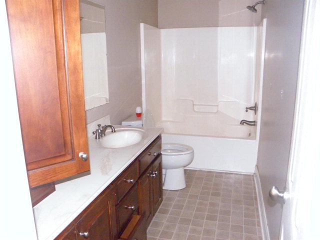 1218 Bowers Cemetery Road Cochran, GA 31014 - Photo 5 of 21 a bathroom with a granite countertop sink toilet and shower