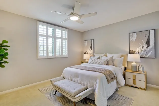 a bathroom with a double vanity sink toilet and mirror