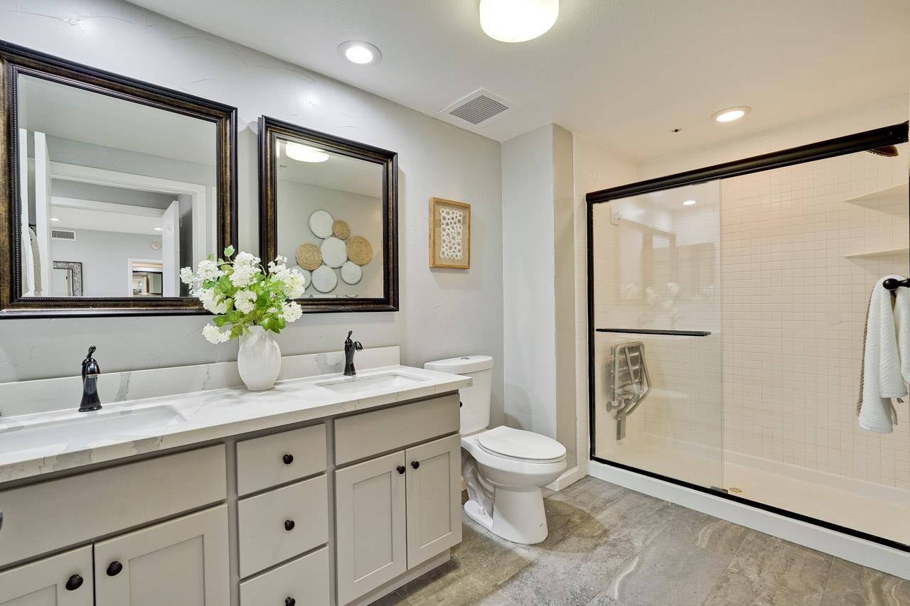 144 South 3rd Street, Unit 425 San Jose, CA 95112 - Photo 17 of 52 a bathroom with a double vanity sink toilet and mirror