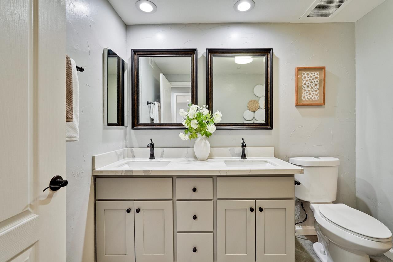 144 South 3rd Street, Unit 425 San Jose, CA 95112 - Photo 19 of 52 a bathroom with a toilet a sink a mirror a and vanity
