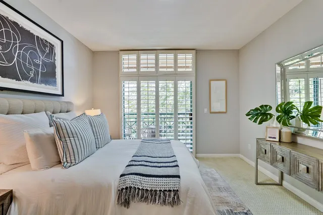 a bedroom with bed and cupboard