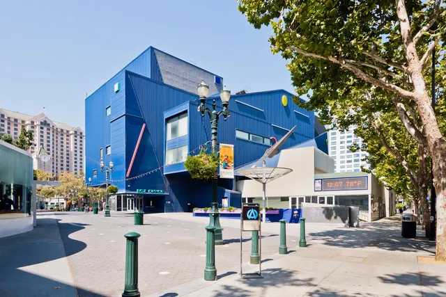 a view of a building with table and chairs